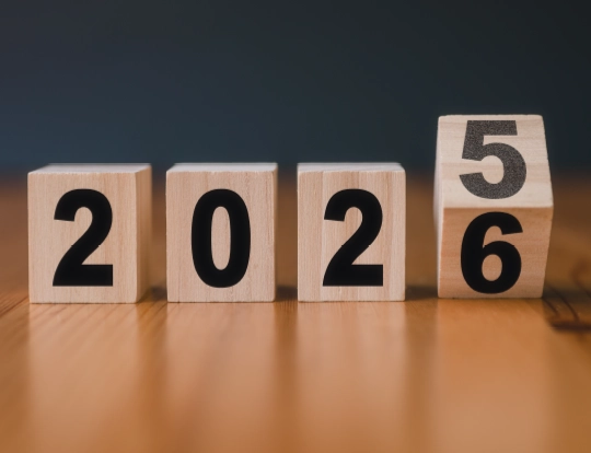 Cover image featuring wooden blocks displaying numbers transitioning from 2025 to 2026, symbolizing the year-end review and outlook report